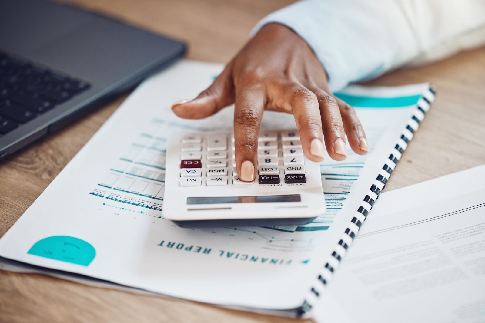 Employee calculating company expenses with a calculator