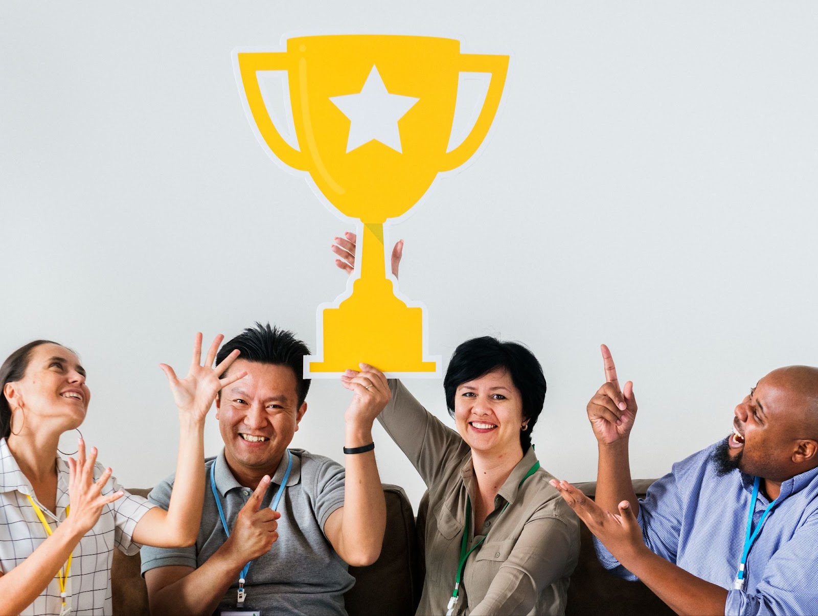 a group of people holding up a trophy standee